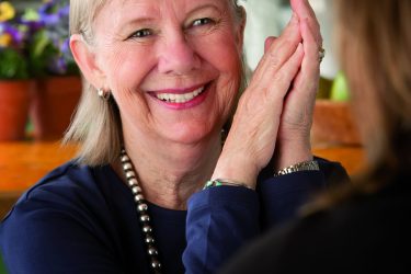 Senior woman in kitchen talking with daughter or friend